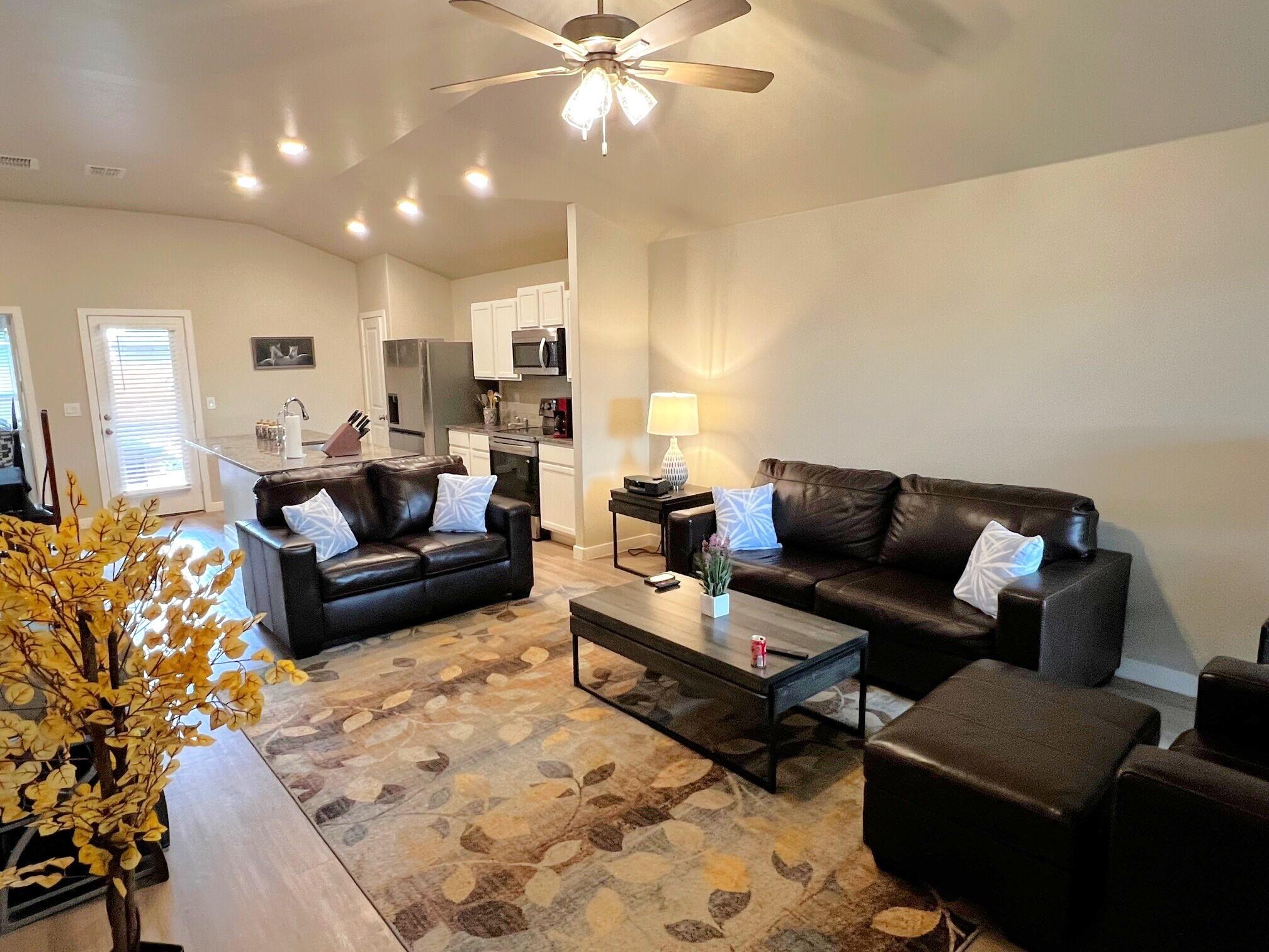 2006 135th Street Lubbock, TX 79423 - Photo 10 of 24 a living room with furniture and a chandelier