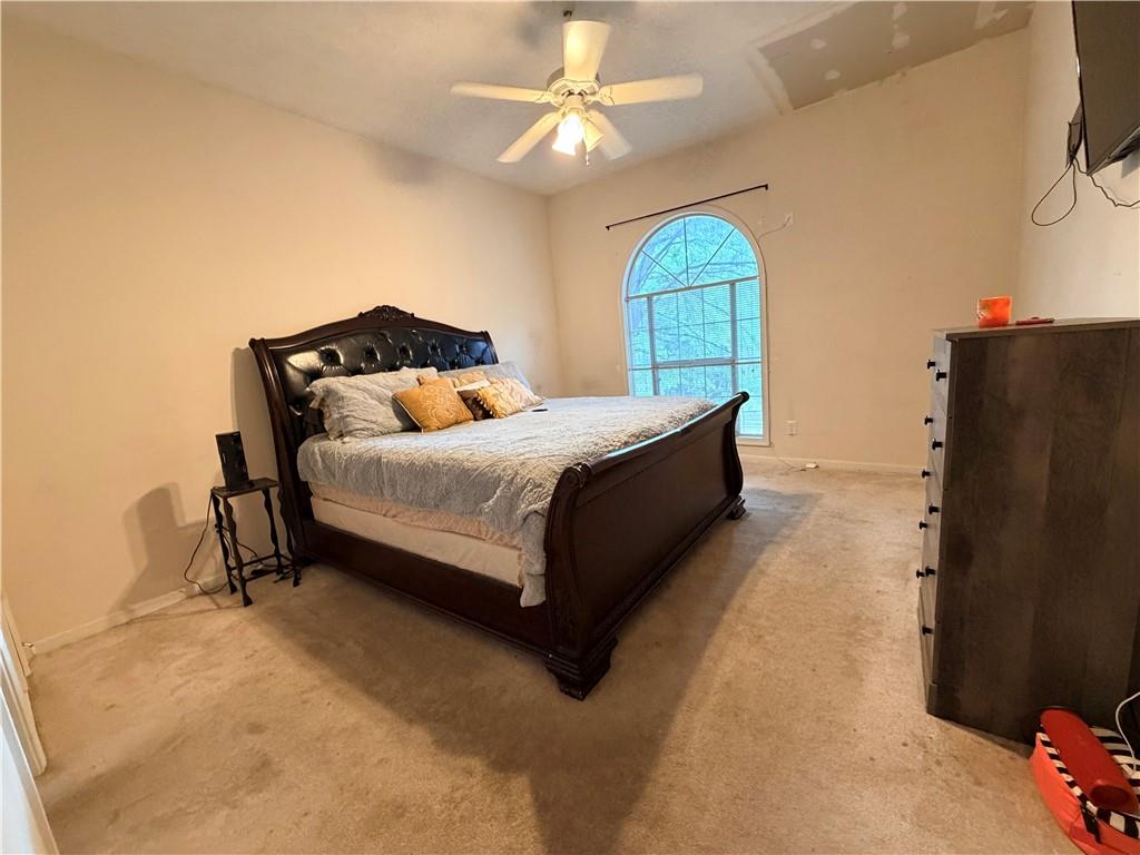 426 Pates Lake Court Hampton, GA 30228 - Photo 34 of 60 a bedroom with a bed dresser and a window