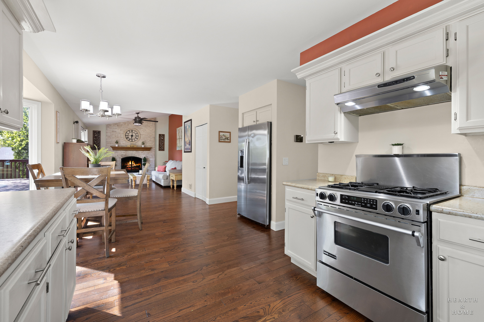 41 Manchester Court Fox River Grove, IL 60021 - Photo 14 of 57 a kitchen with stainless steel appliances a stove top oven a refrigerator a dining table and chairs with wooden floor