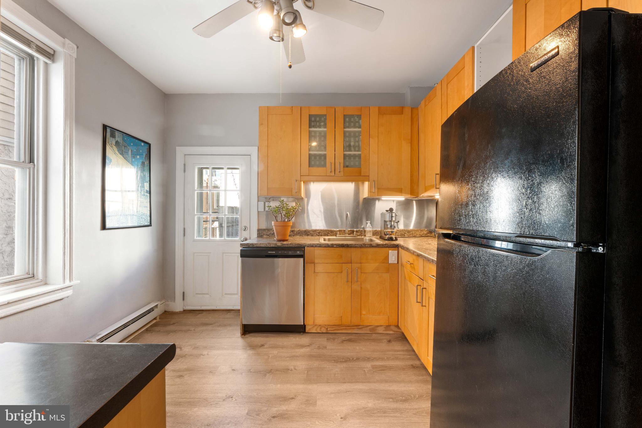 134 Davis Street Philadelphia, PA 19127 - Photo 13 of 33 a kitchen with stainless steel appliances granite countertop a refrigerator and a sink