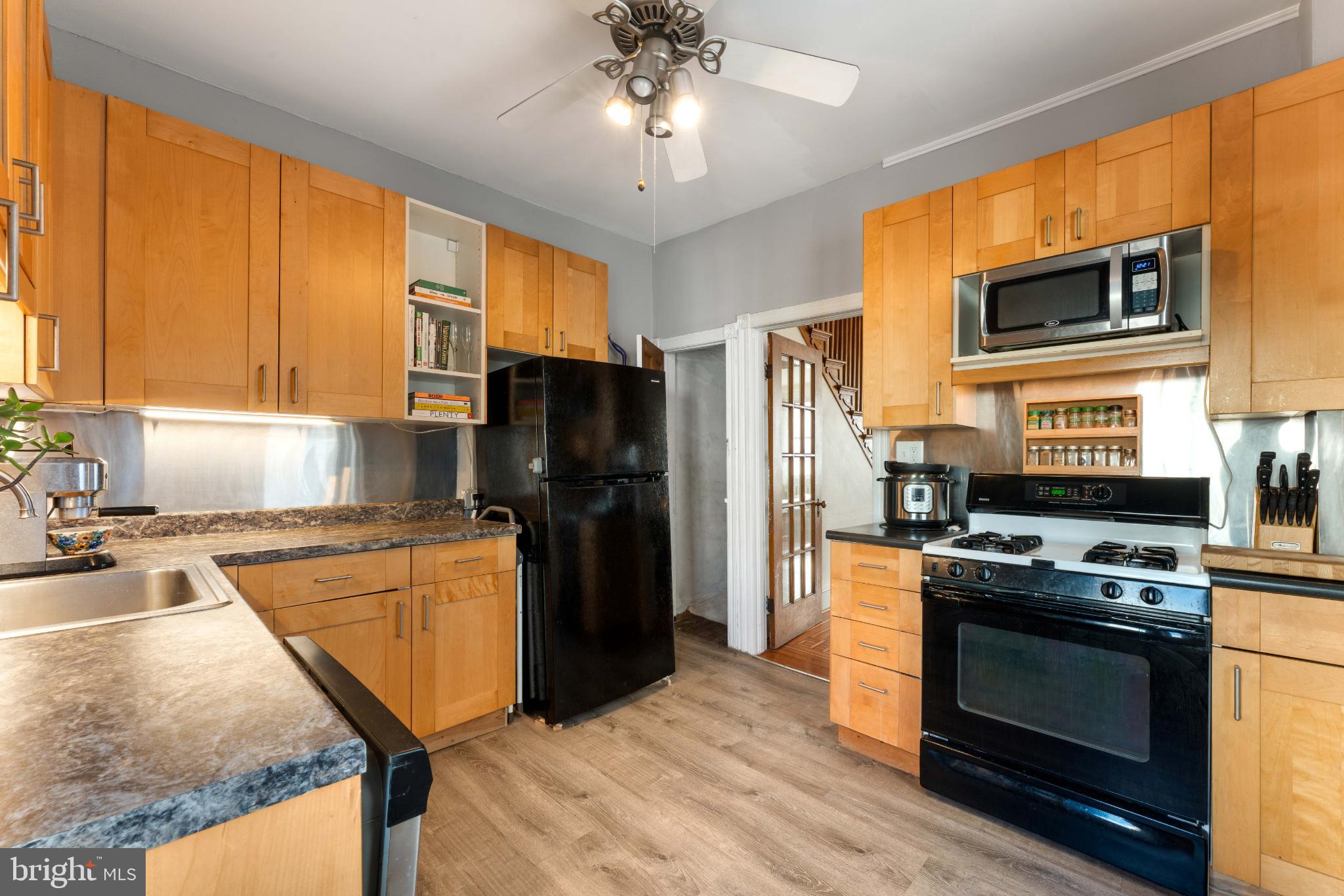 134 Davis Street Philadelphia, PA 19127 - Photo 14 of 33 a kitchen with stainless steel appliances granite countertop a refrigerator stove and sink