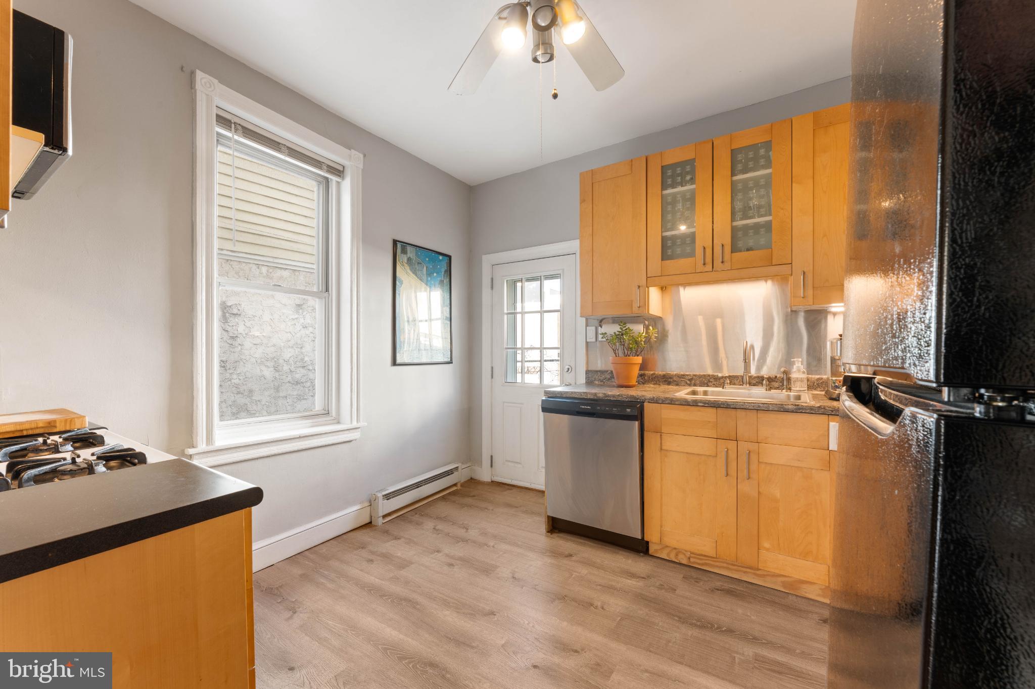 134 Davis Street Philadelphia, PA 19127 - Photo 16 of 33 a kitchen with stainless steel appliances granite countertop a stove a sink and a refrigerator