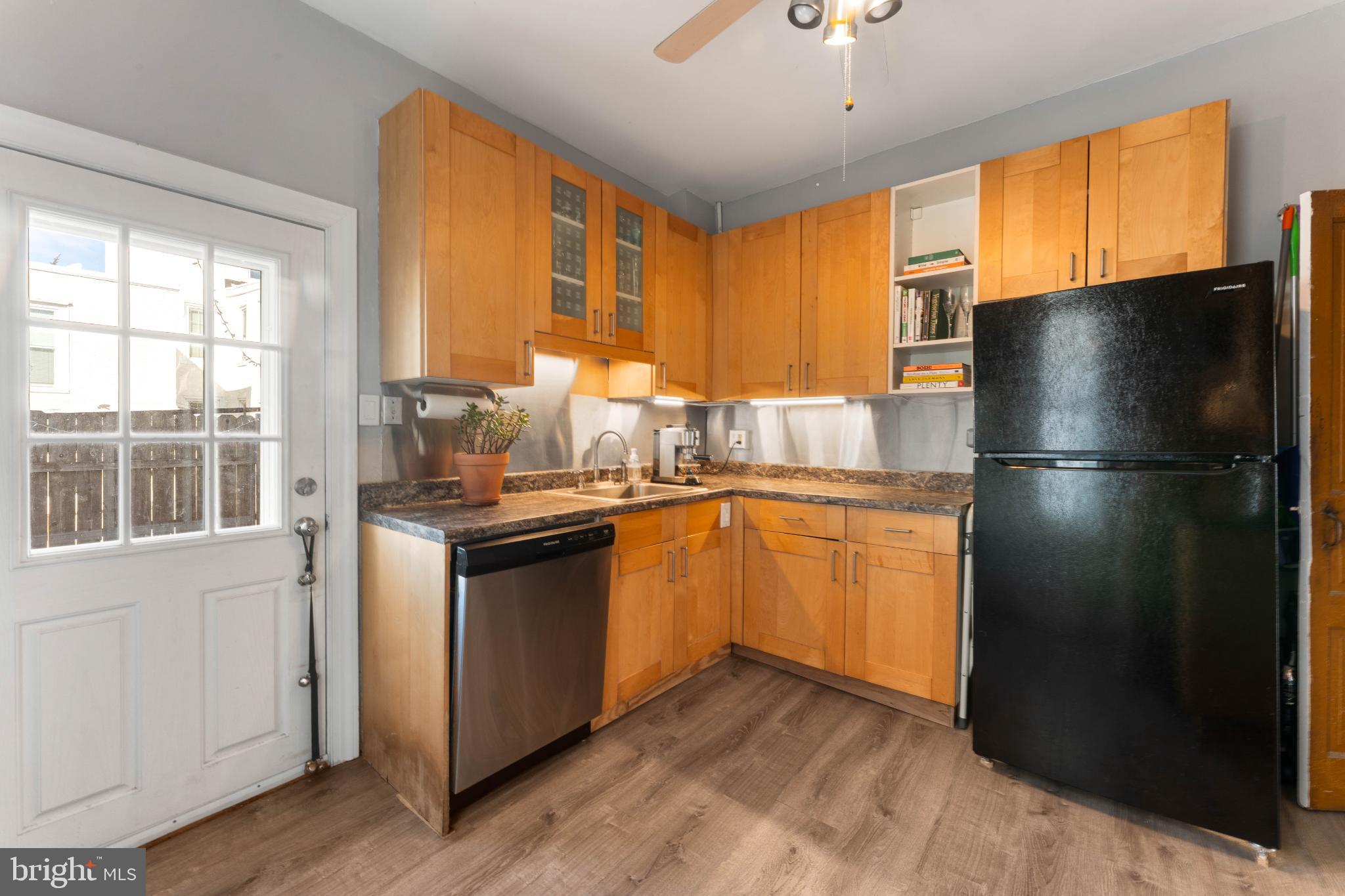134 Davis Street Philadelphia, PA 19127 - Photo 17 of 33 a kitchen with granite countertop stainless steel appliances a refrigerator cabinets and a large window