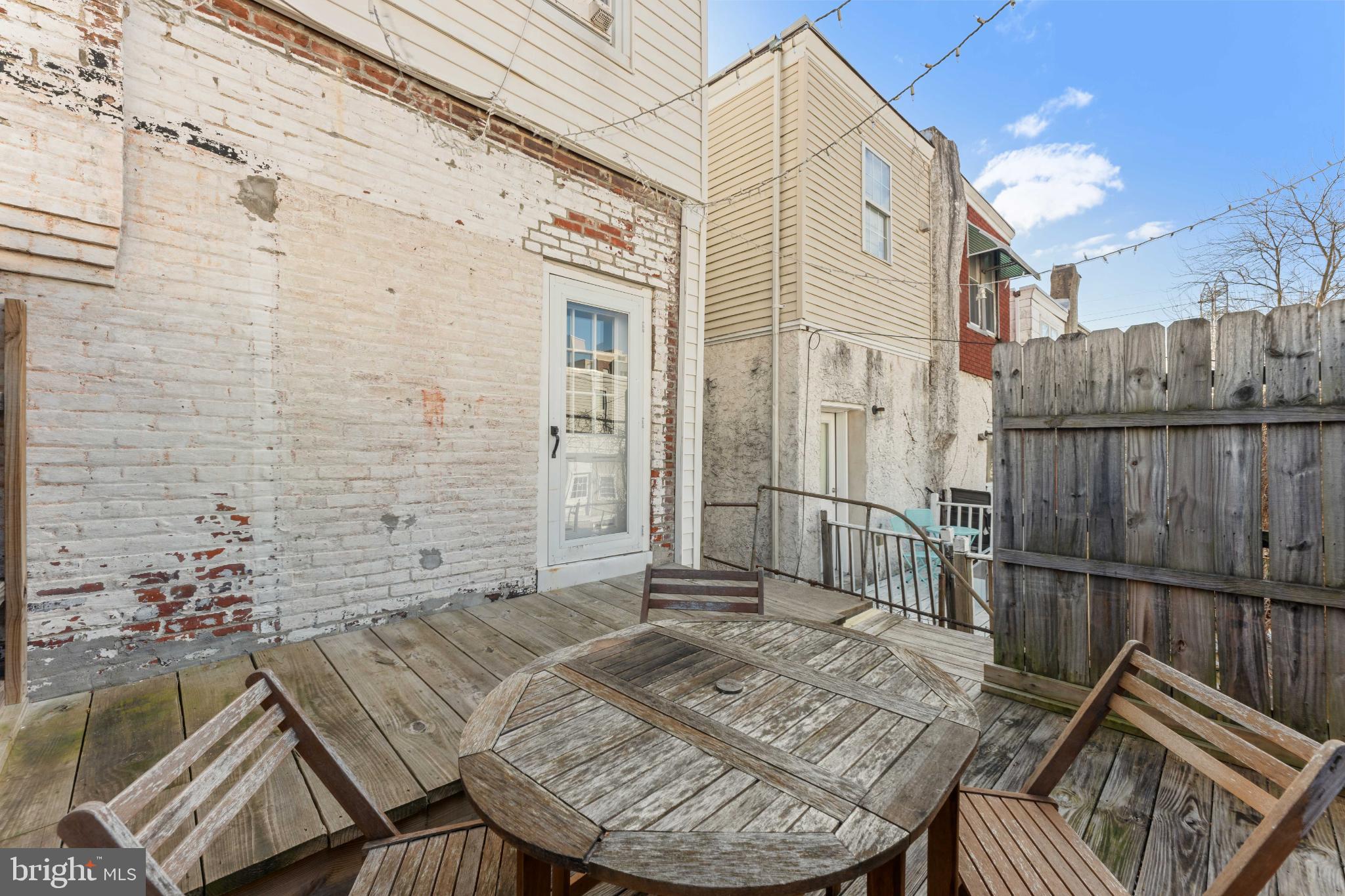 134 Davis Street Philadelphia, PA 19127 - Photo 30 of 33 a view of a patio with table and chairs with wooden floor and fence