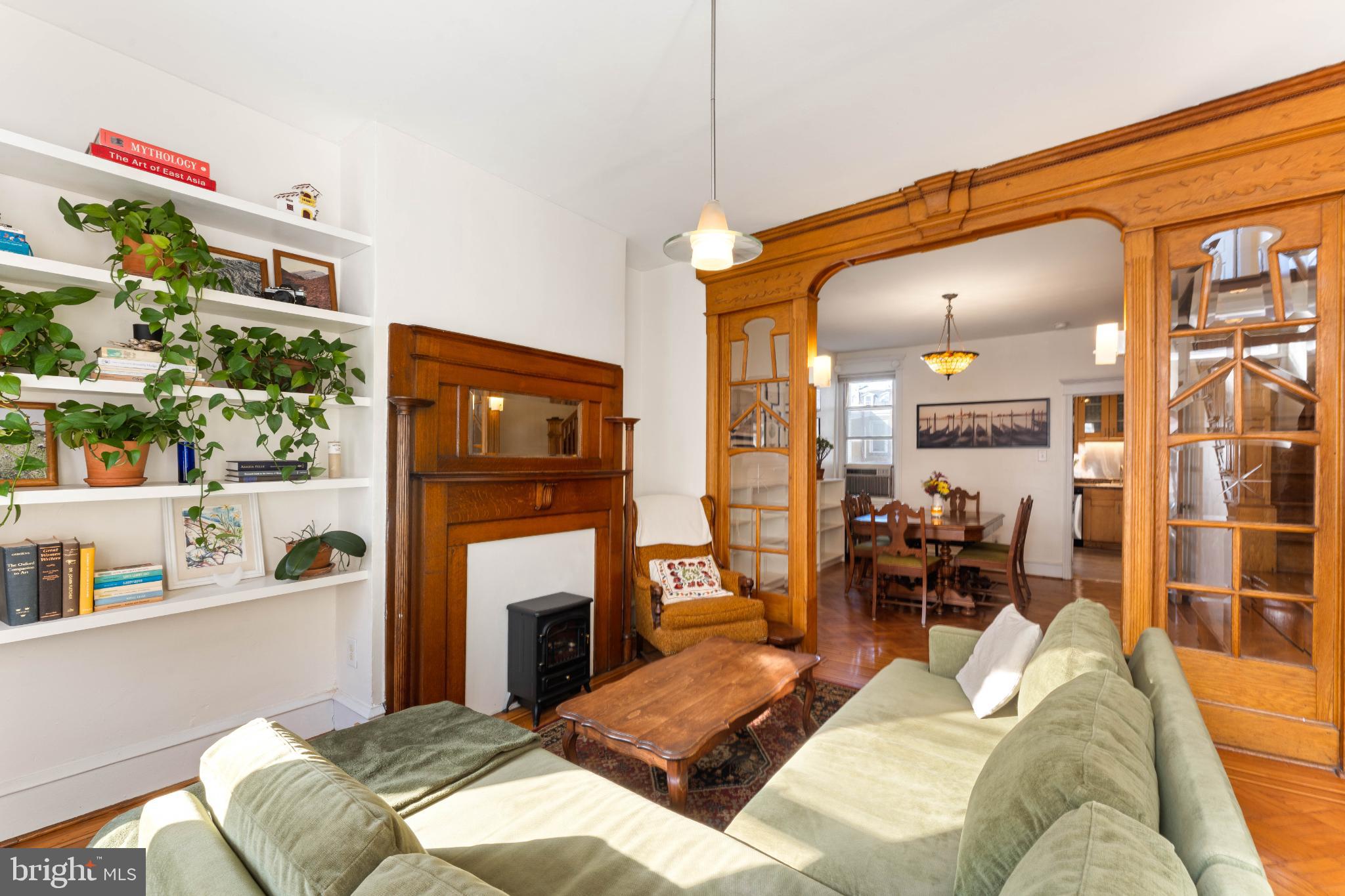 134 Davis Street Philadelphia, PA 19127 - Photo 5 of 33 a living room with furniture a fireplace and a kitchen view
