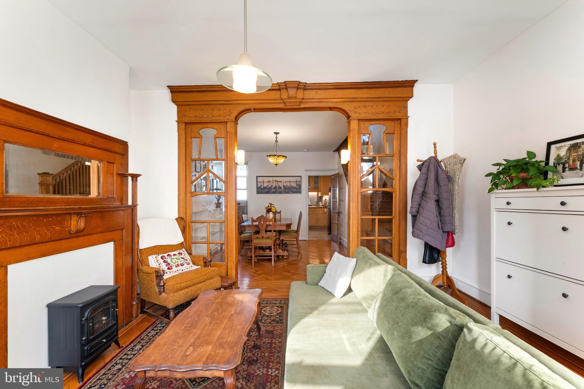 134 Davis Street Philadelphia, PA 19127 - Photo 6 of 33 a living room with furniture a flat screen tv and a fireplace