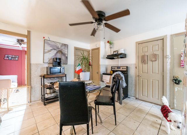 a view of a dining room with furniture and a window