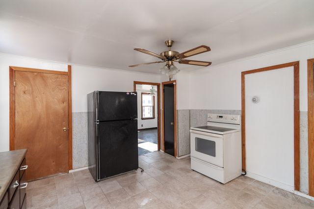 a view of a kitchen with a sink and cabinet