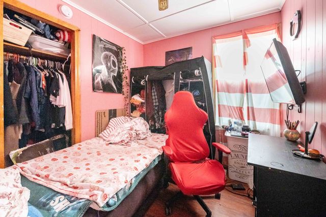 a bedroom with bed and a couch