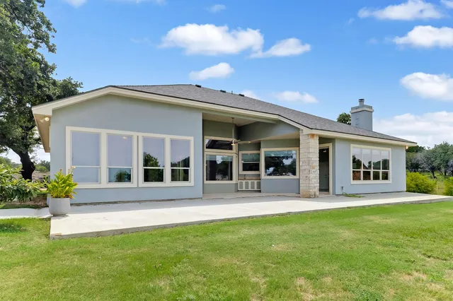 a front view of a house with a garden and plants
