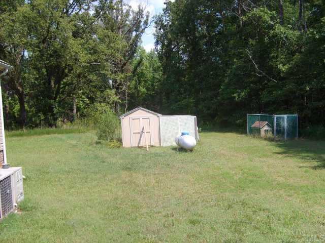 2770 Bart Road Middlesex, NC 27557 - Photo 3 of 6 a backyard of a house with table and chairs