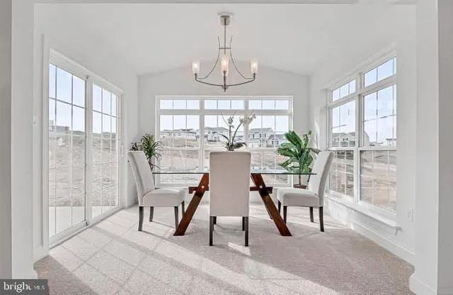 a view of a dining room with furniture wooden floor and chandelier