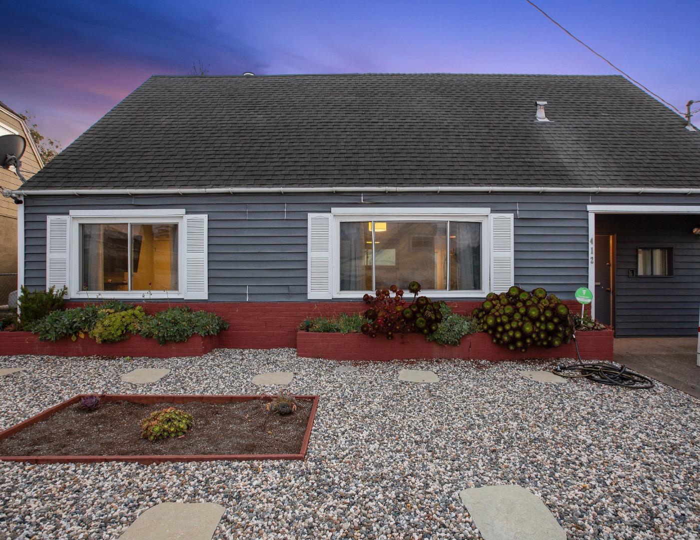 a front view of a house with garden