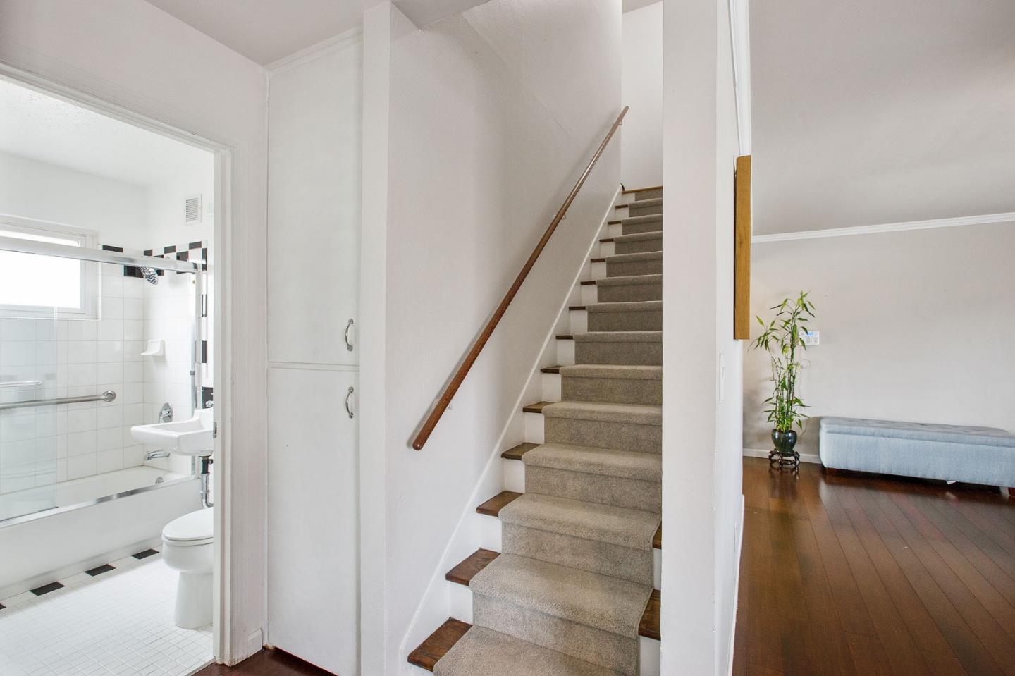 412 Lomond Drive Pacifica, CA 94044 - Photo 11 of 26 a view of a hallway with wooden floor and staircase