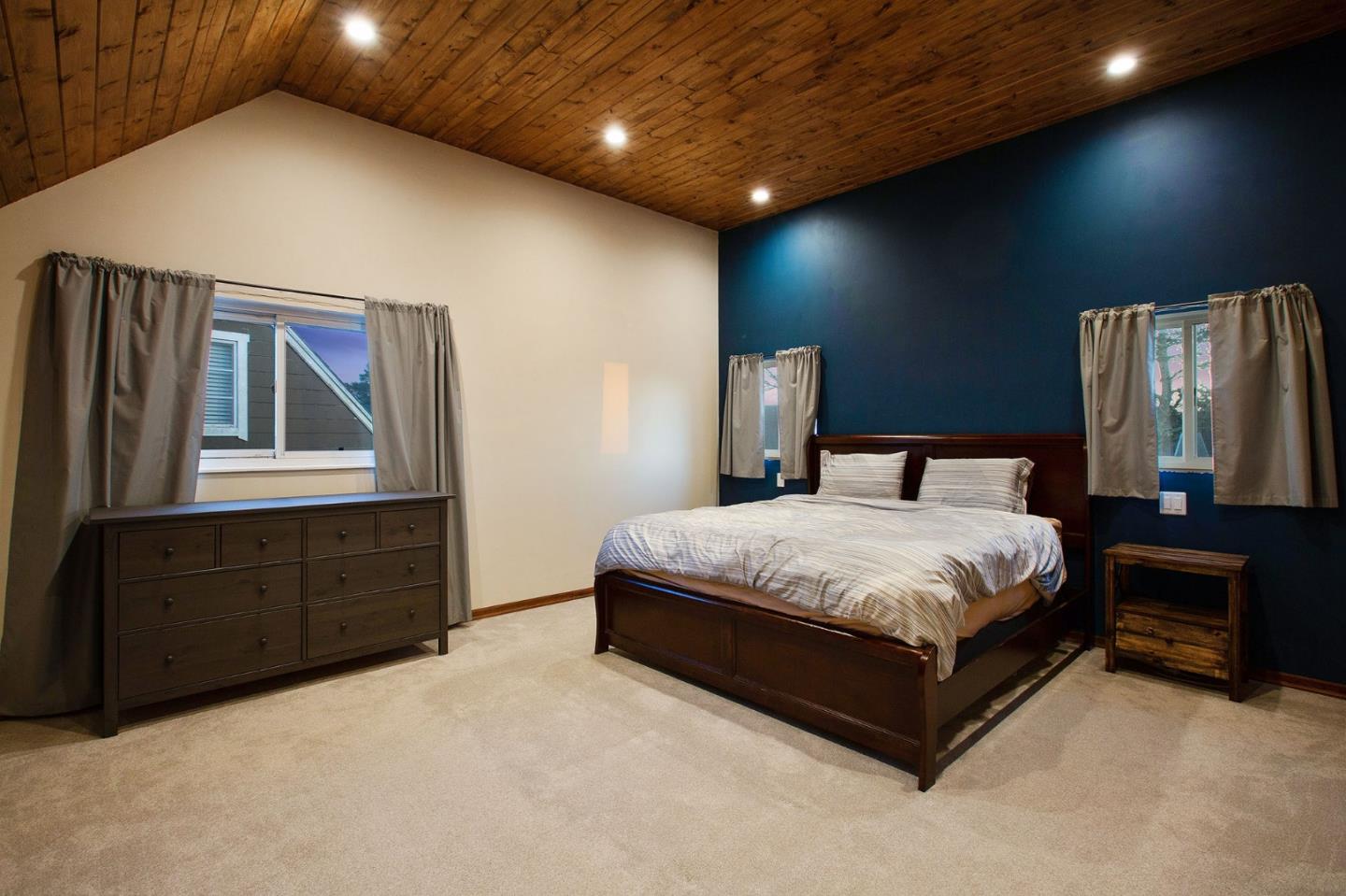 412 Lomond Drive Pacifica, CA 94044 - Photo 25 of 26 a bedroom with a bed and a dresser