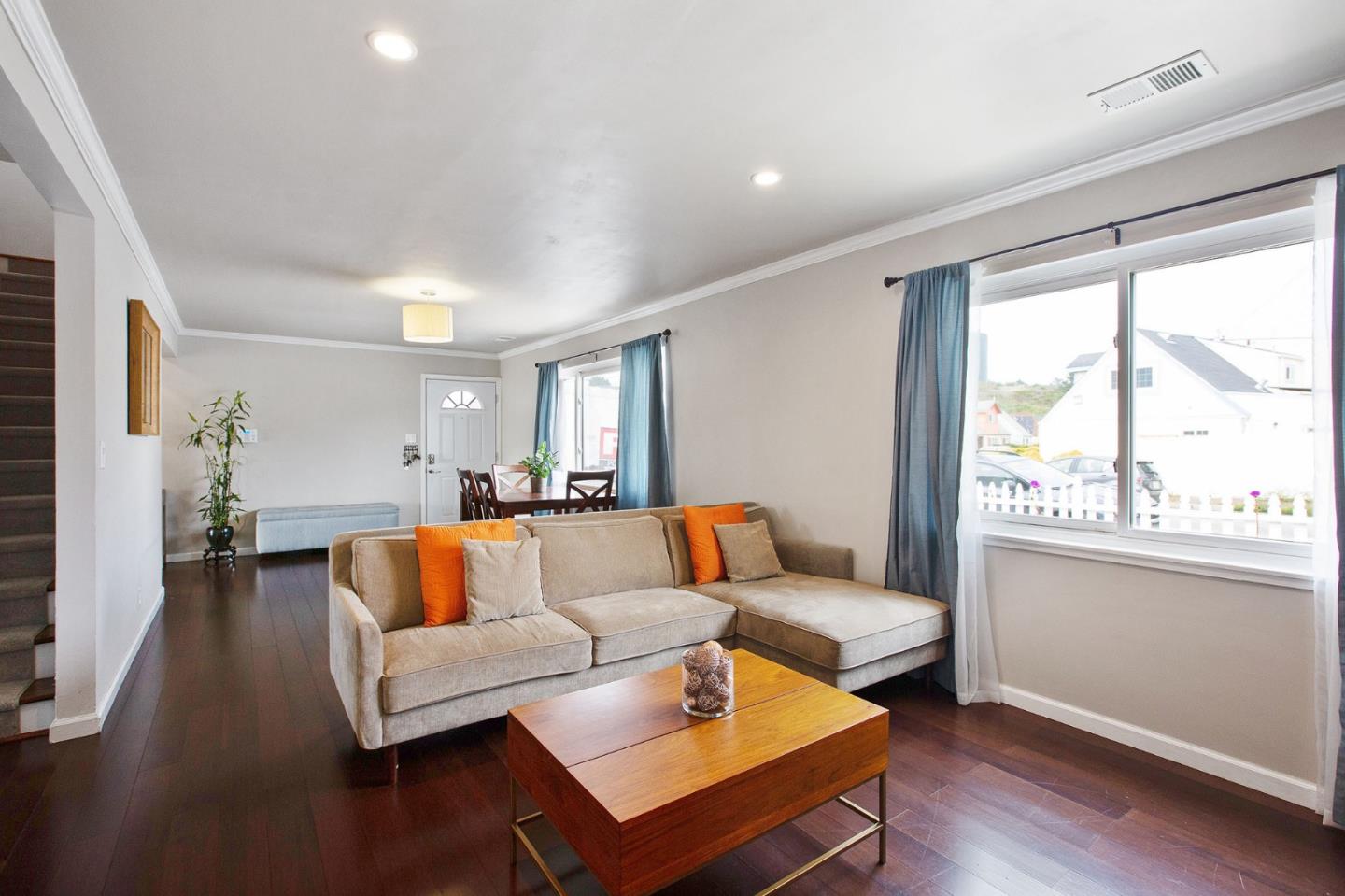 412 Lomond Drive Pacifica, CA 94044 - Photo 4 of 26 a living room with furniture and a large window