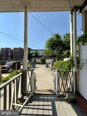 a view of a patio with table and chairs potted plants with wooden floor