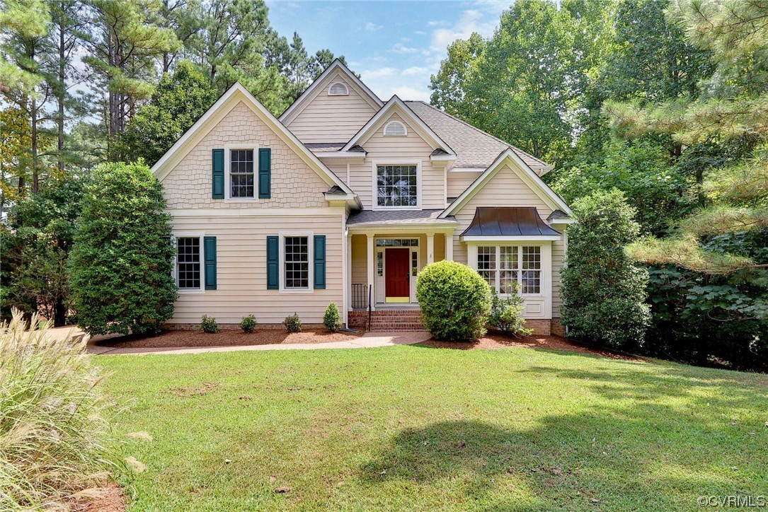 a front view of a house with a yard and porch