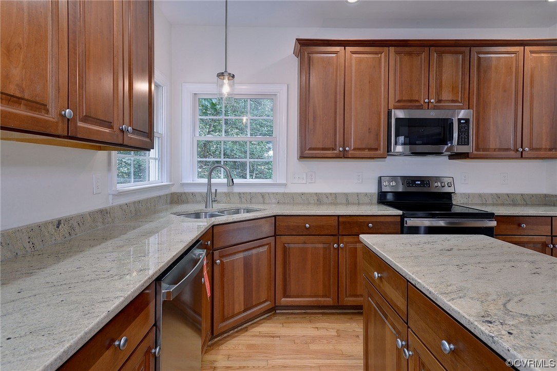5531 Scotsview Drive Providence Forge, VA 23140 - Photo 12 of 42 a kitchen with granite countertop stainless steel appliances a sink dishwasher and cabinets with wooden floor