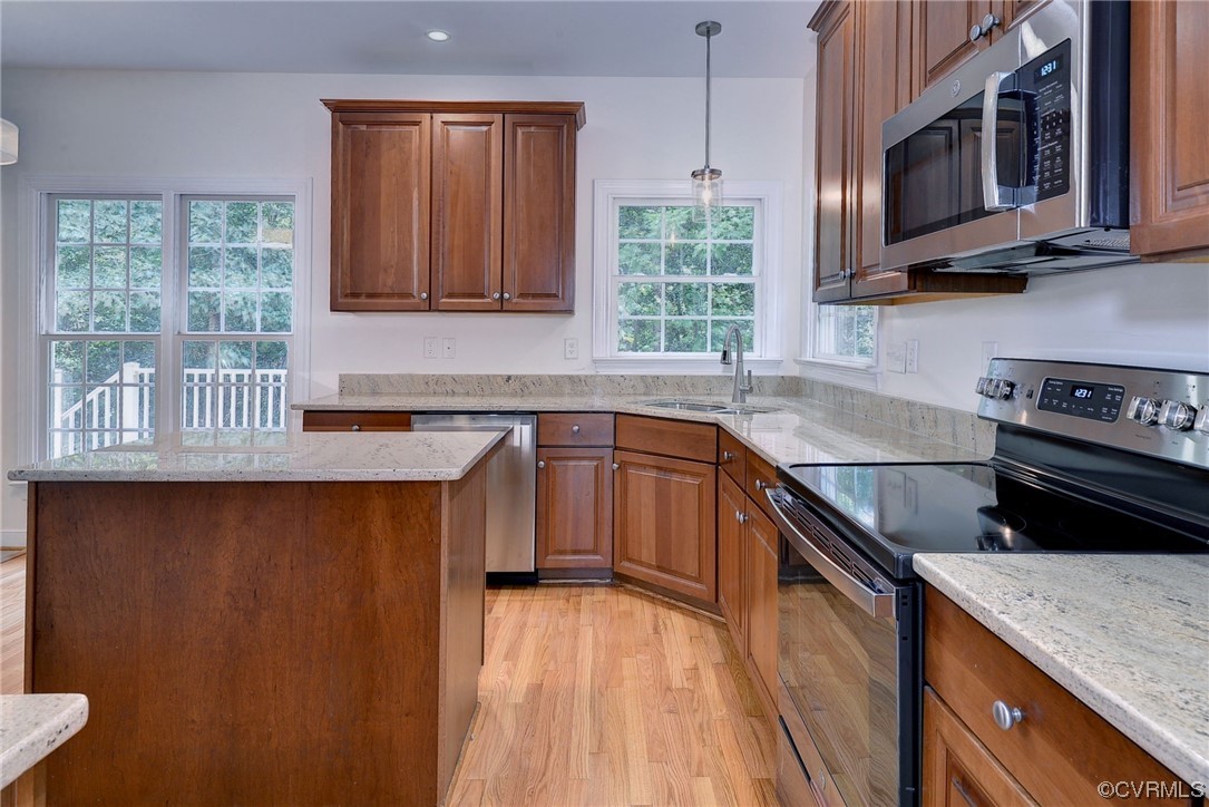 5531 Scotsview Drive Providence Forge, VA 23140 - Photo 13 of 42 a kitchen with stainless steel appliances granite countertop a sink a stove a microwave cabinets and a wooden floor