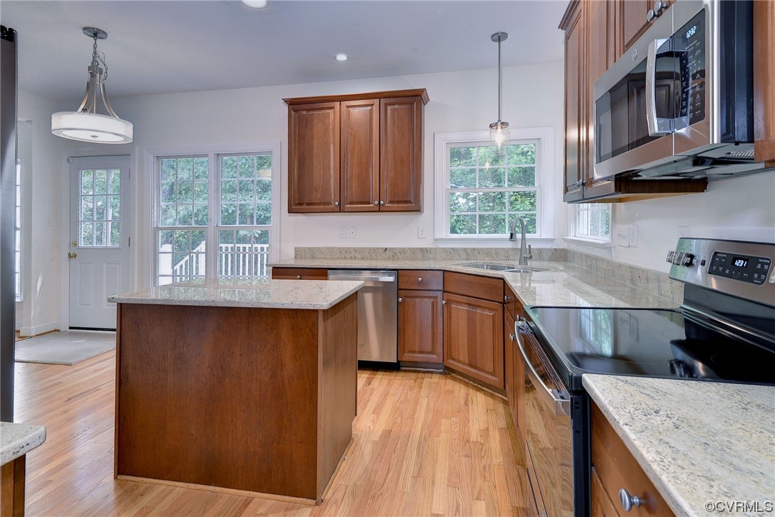 5531 Scotsview Drive Providence Forge, VA 23140 - Photo 14 of 42 a kitchen with stainless steel appliances granite countertop wooden cabinets a stove a sink and a wooden floor