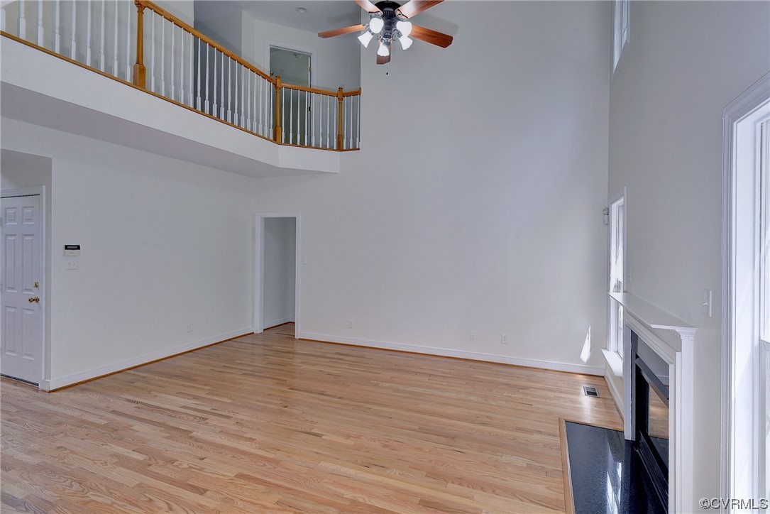 5531 Scotsview Drive Providence Forge, VA 23140 - Photo 8 of 42 an empty room with wooden floor and a chandelier