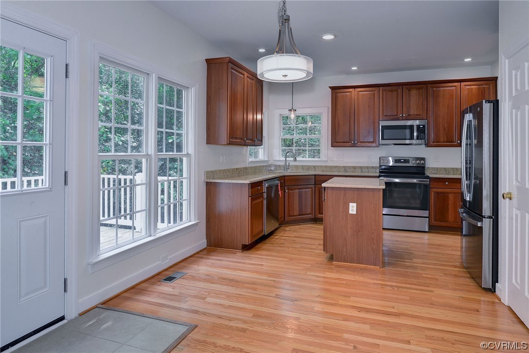 5531 Scotsview Drive Providence Forge, VA 23140 - Photo 10 of 42 a kitchen with stainless steel appliances granite countertop a stove a sink dishwasher a refrigerator and a oven with wooden floor