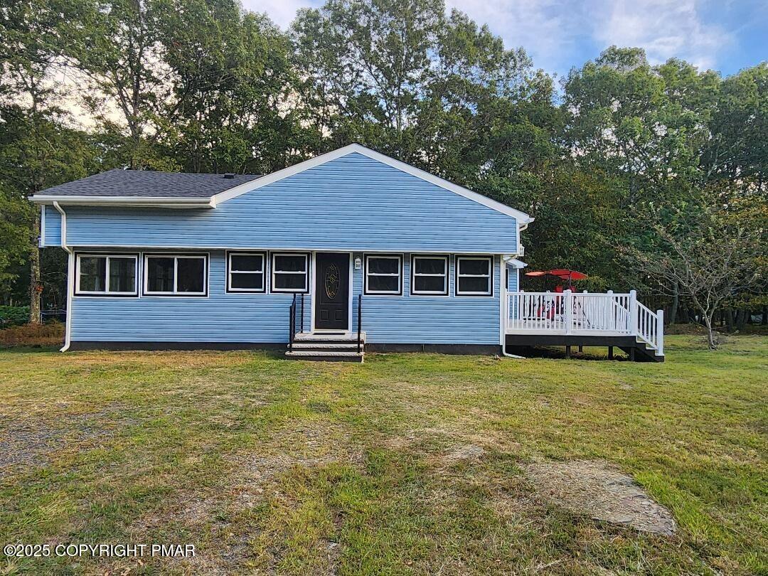 22 Mountain Top Road East Stroudsburg, PA 18302 - Photo 1 of 9 a backyard of a house with yard table and chairs