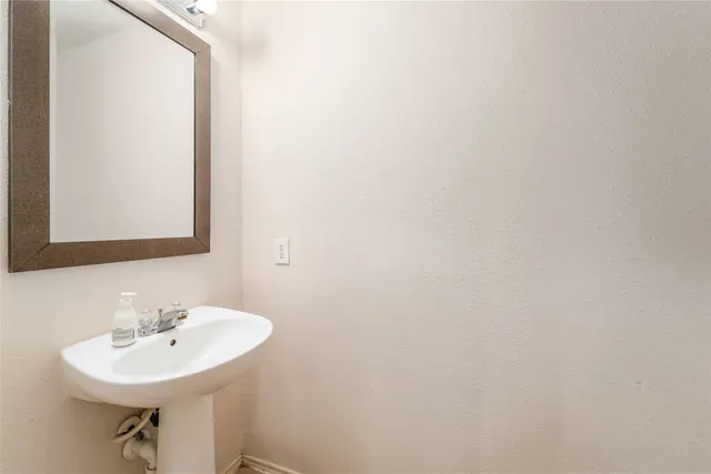 a bathroom with a sink a mirror and a toilet