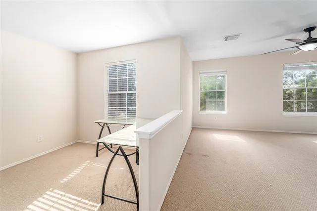 a front view of a house with a garden and trees