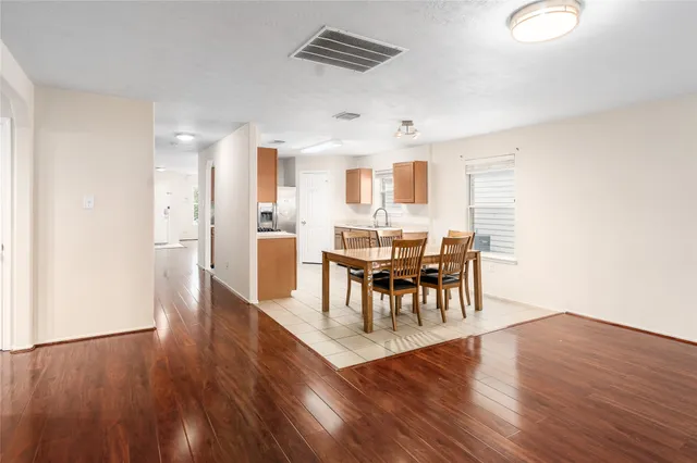a view of a dining room with furniture and wooden floor
