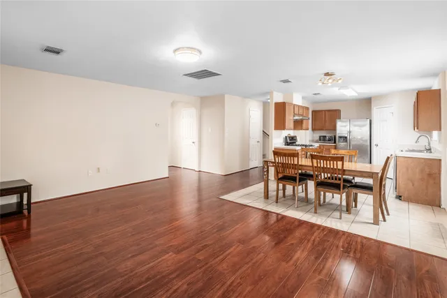 a view of a a dining room with furniture window and wooden floor