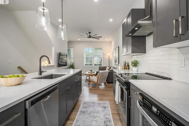 a kitchen with sink stove and cabinets