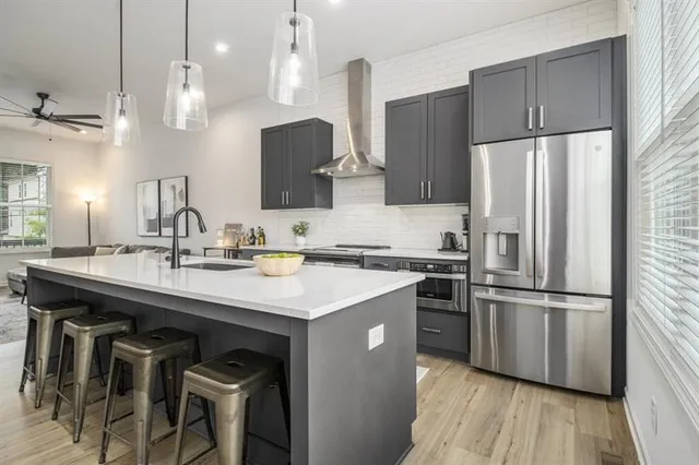 a kitchen with kitchen island a sink appliances and cabinets