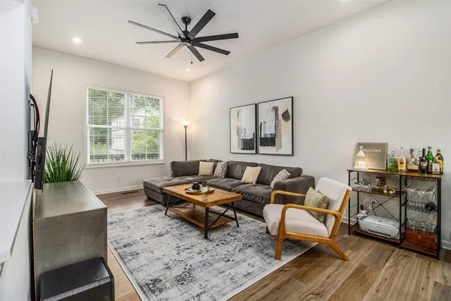 a living room with furniture and wooden floor
