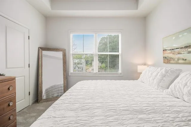 a bedroom with a large bed and a window