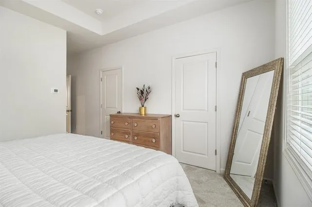 a bedroom with a bed and a mirror