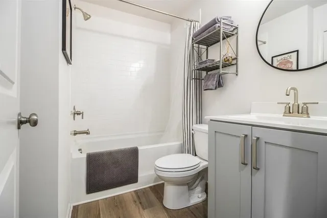 a bathroom with a toilet sink and shower
