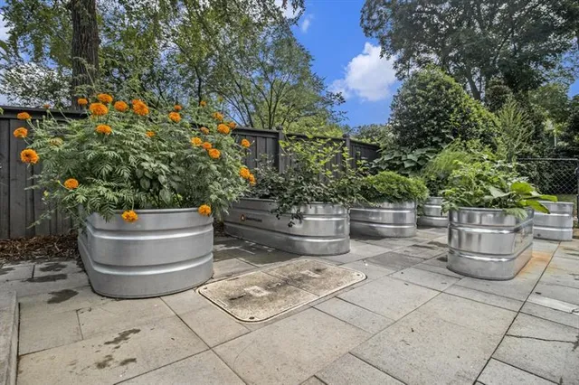 a view of a patio with couple of flower plants