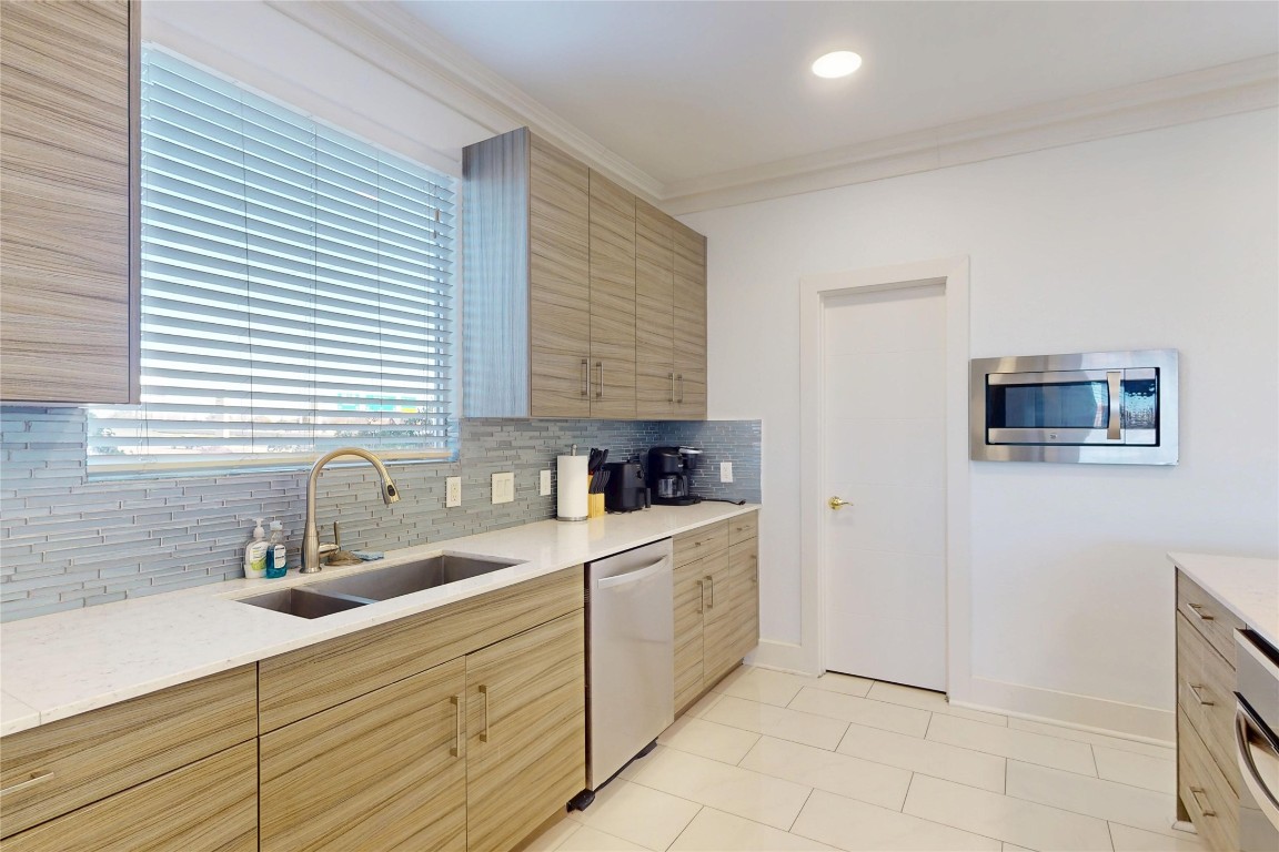 2023 Rosedale Street Houston, TX 77004 - Photo 11 of 30 a kitchen with stainless steel appliances a sink stove and cabinets