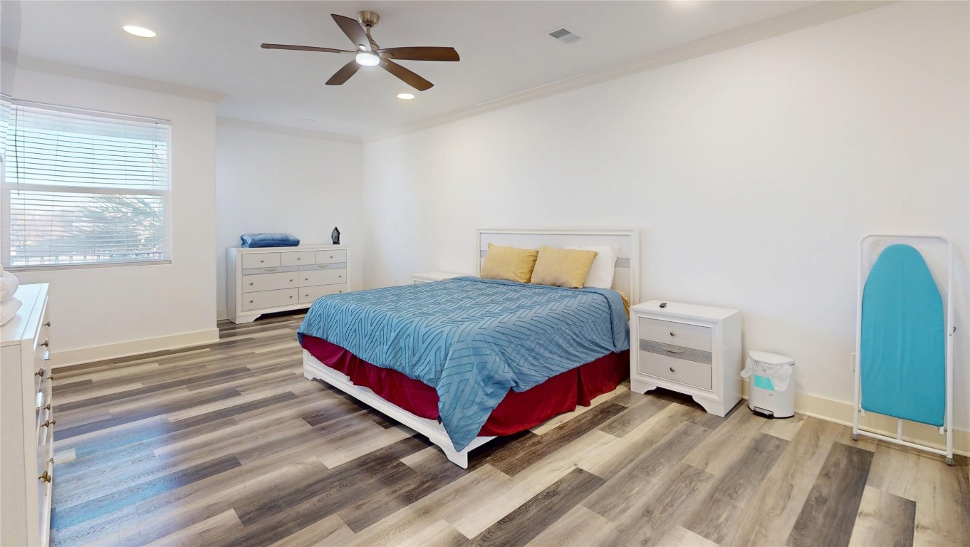 2023 Rosedale Street Houston, TX 77004 - Photo 19 of 30 a bedroom with a bed and wooden floor
