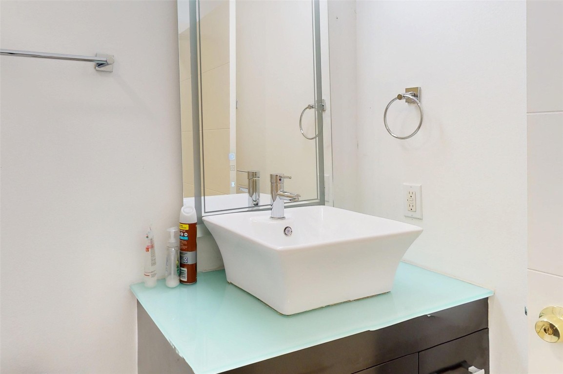 2023 Rosedale Street Houston, TX 77004 - Photo 25 of 30 a bathroom with a sink and mirror