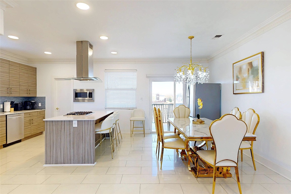 2023 Rosedale Street Houston, TX 77004 - Photo 10 of 30 a kitchen with kitchen island a dining table and chairs