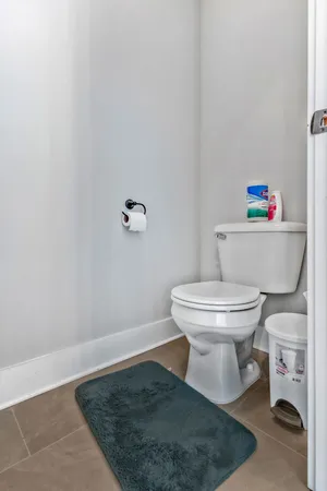 a white toilet sitting next to a white cabinet