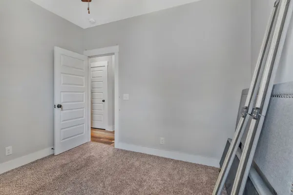 a bedroom with bed and a window