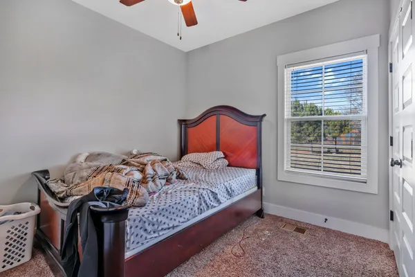 a bedroom with a bed and cabinet