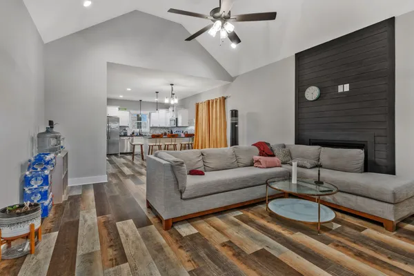 a living room with furniture and a chandelier