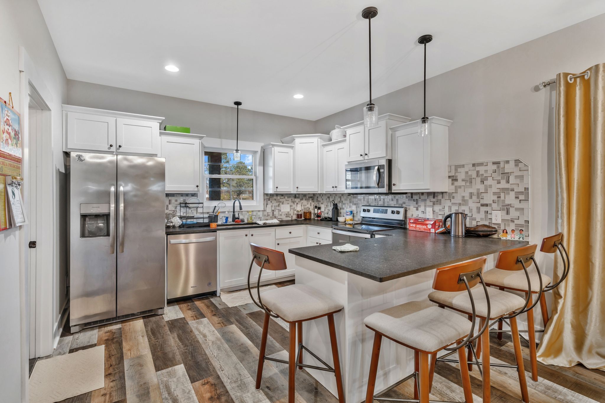 155 Julia Ann Court Springfield, TN 37172 - Photo 8 of 24 a kitchen with stainless steel appliances granite countertop a refrigerator a sink dishwasher a stove and white cabinets with wooden floor