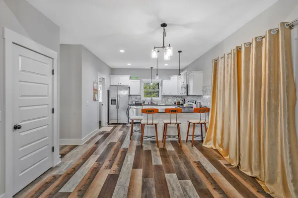 a open kitchen with stainless steel appliances granite countertop a refrigerator and a sink