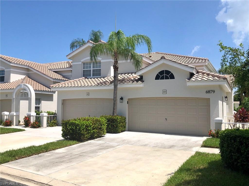 6879 Redbay Park Road, Unit 203 Naples, FL 34109 - Photo 1 of 34 a front view of a house with a yard